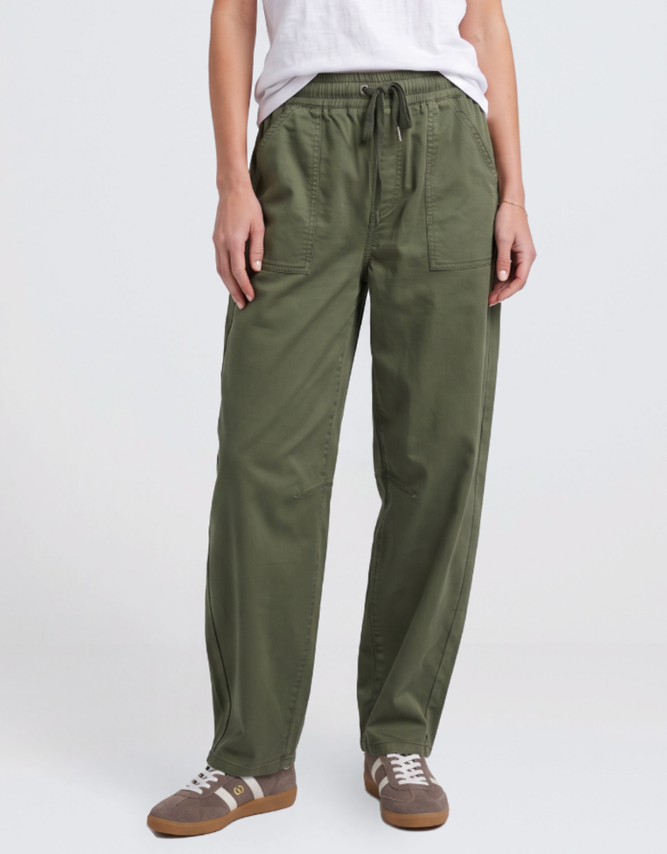 Image of a model wearing Pants. Product name - Quinn Barrel Jogger Basil in Basil colour by brand - Elm