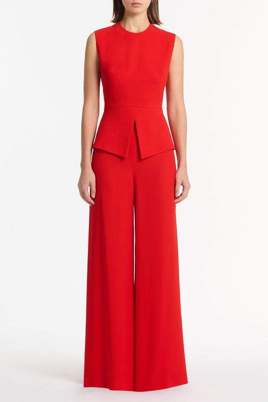 Image of a model wearing Tops. Product name - Red Crepe Peplum Top in Red colour by brand - Carla Zampatti