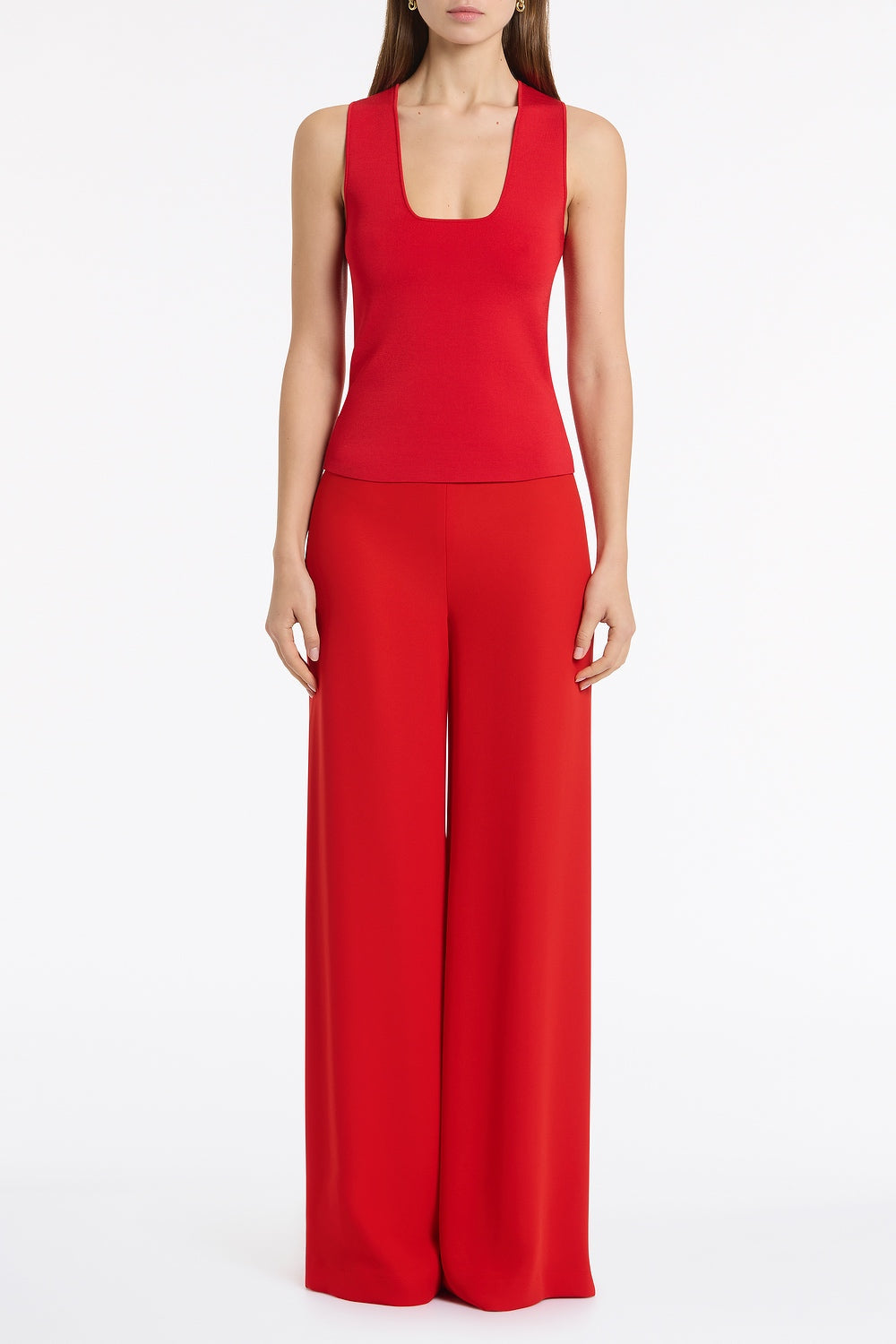 Image of a model wearing Tops. Product name - Red Milano Knit Tank in Red colour by brand - Carla Zampatti