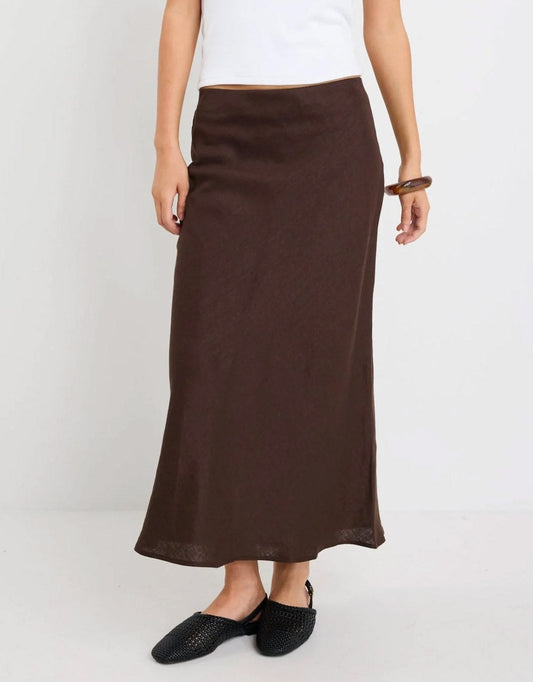 Image of a model wearing Skirts. Productname: Bliss Linen Bias Midi Skirt - in Dark Chocolate colour by brand - Re:Union The Label