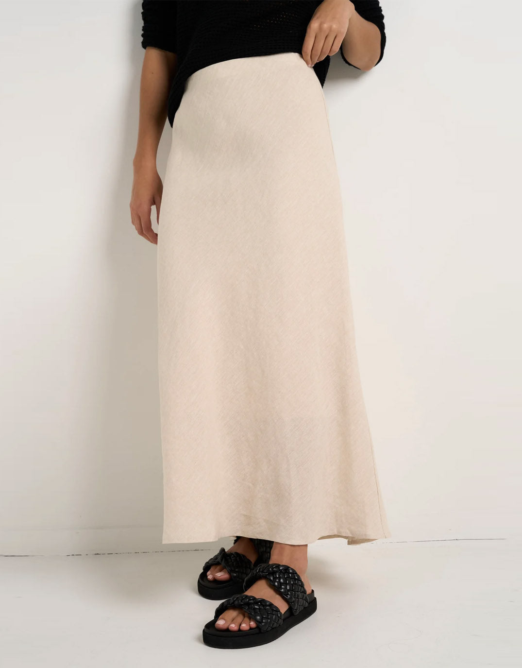 Image of a model wearing Skirts. Productname: Bliss Linen Bias Midi Skirt - in Natural colour by brand - Re:Union The Label