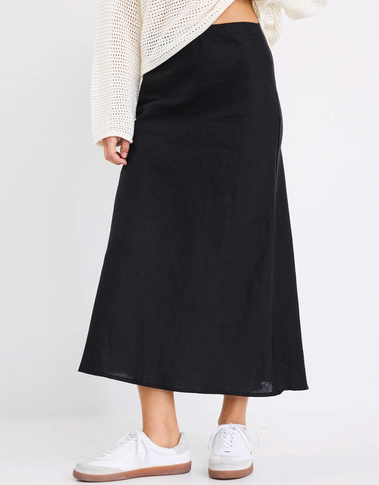 Image of a model wearing Skirts. Productname: Bliss Linen Bias Midi Skirt - in Black colour by brand - Re:Union The Label
