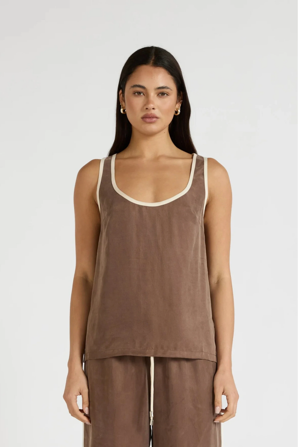 Image of a model wearing Tops. Product name - Cupro Contrast Tank in Latte colour by brand - All Fenix