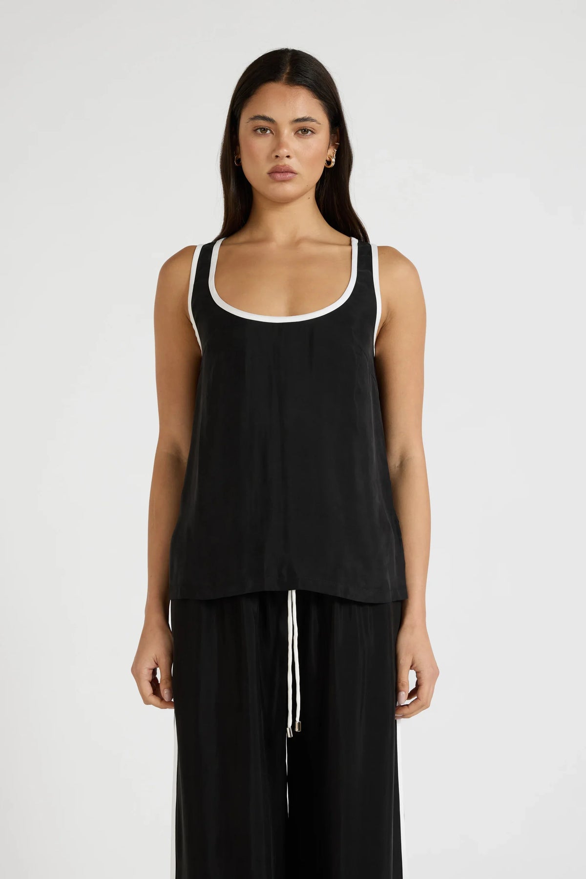 Image of a model wearing Tops. Product name - Cupro Contrast Tank in Black colour by brand - All Fenix