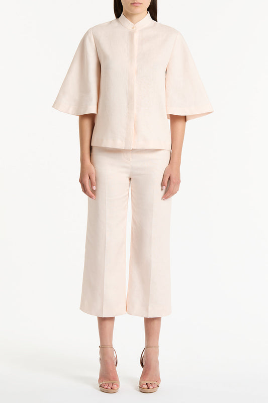 Image of a model wearing Tops. Product name - Rosa Linen Box Sleeve Shirt in Pink colour by brand - Carla Zampatti