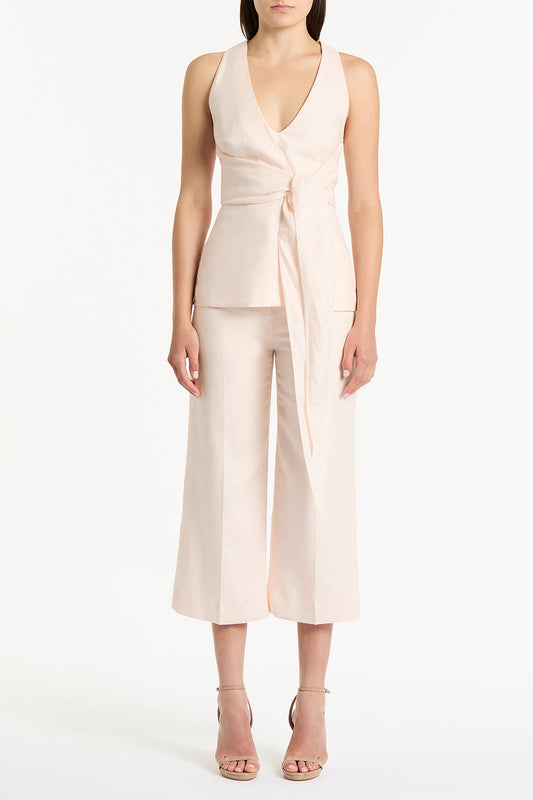 Image of a model wearing Tops. Product name - Rosa Linen V-Neck Wrap Top in Pink colour by brand - Carla Zampatti