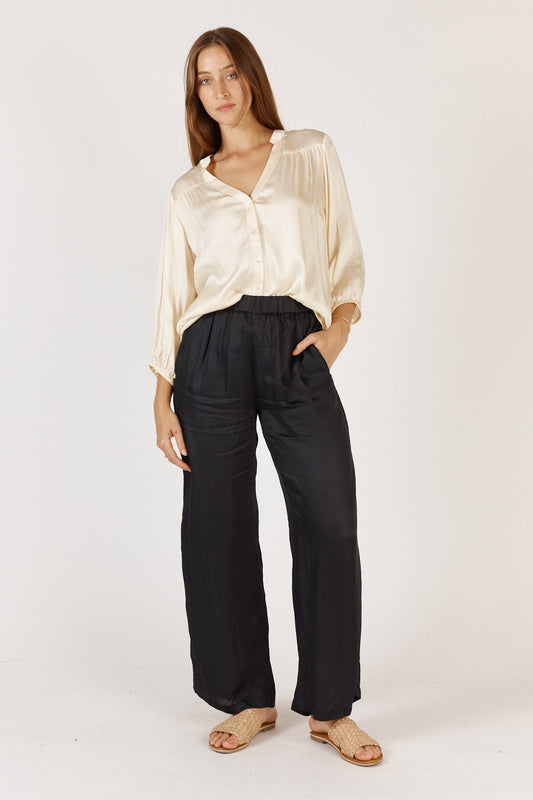Image of a model wearing Pants. Product name - Rubyyaya Munchen Pant Black in Black colour by brand - Rubyyaya
