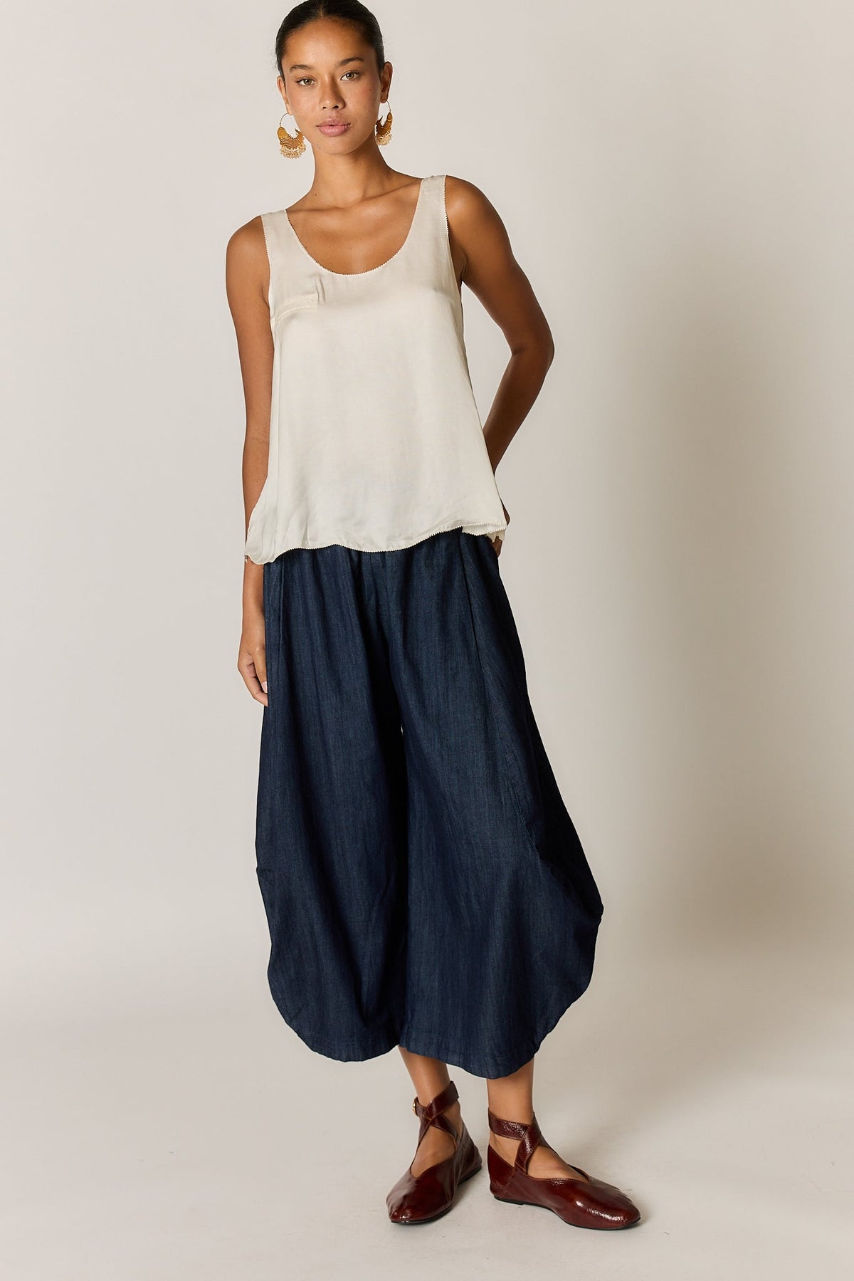 Image of a model wearing Tops. Product name - Rubyyaya Munchen Singlet Cream in Cream colour by brand - Rubyyaya