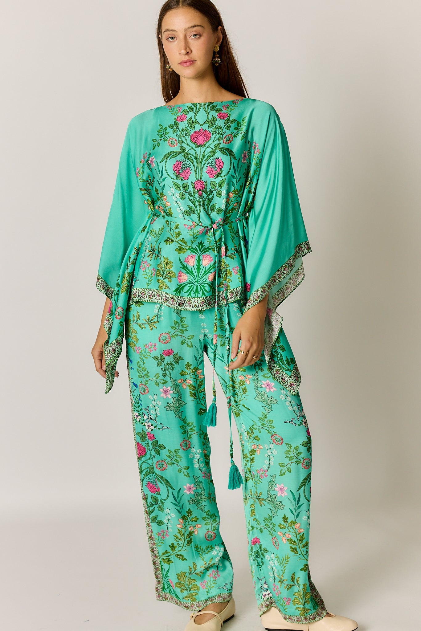 Image of a model wearing Outerwear. Product name - PRE SALE | Rubyyaya Tatiana Poncho Green in Green colour by brand - Rubyyaya