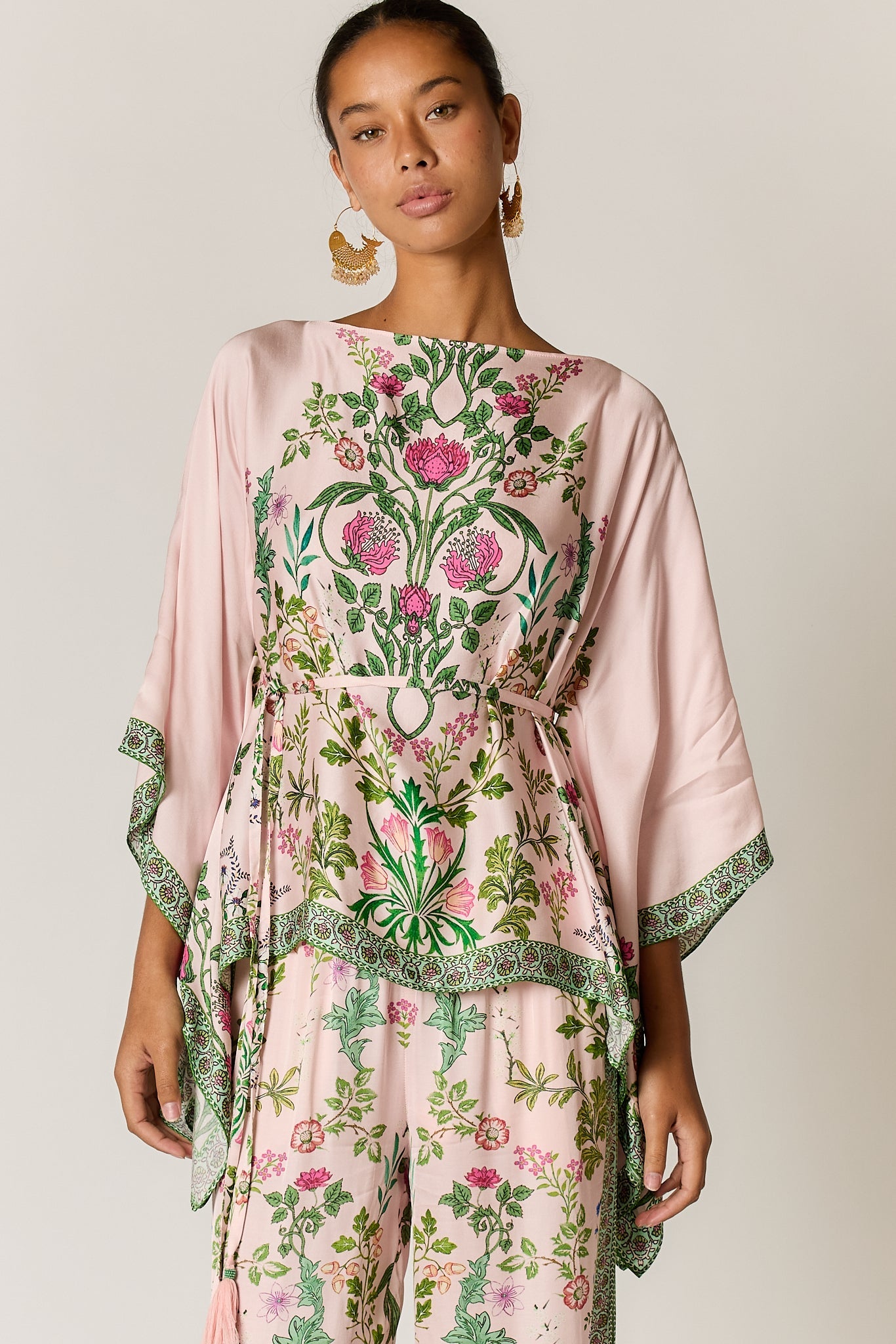 Image of a model wearing Outerwear. Product name - PRE SALE | Tatiana Poncho Pink in Pink colour by brand - Rubyyaya
