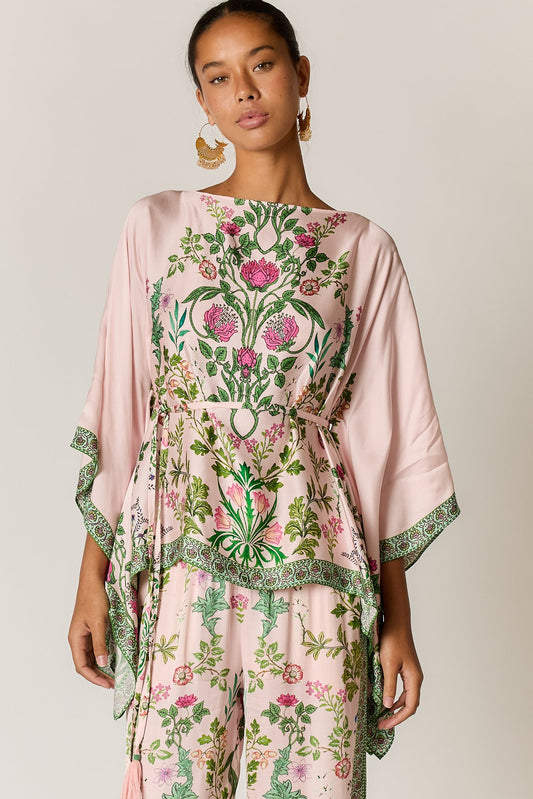 Image of a model wearing Outerwear. Product name - PRE SALE | Tatiana Poncho Pink in Pink colour by brand - Rubyyaya