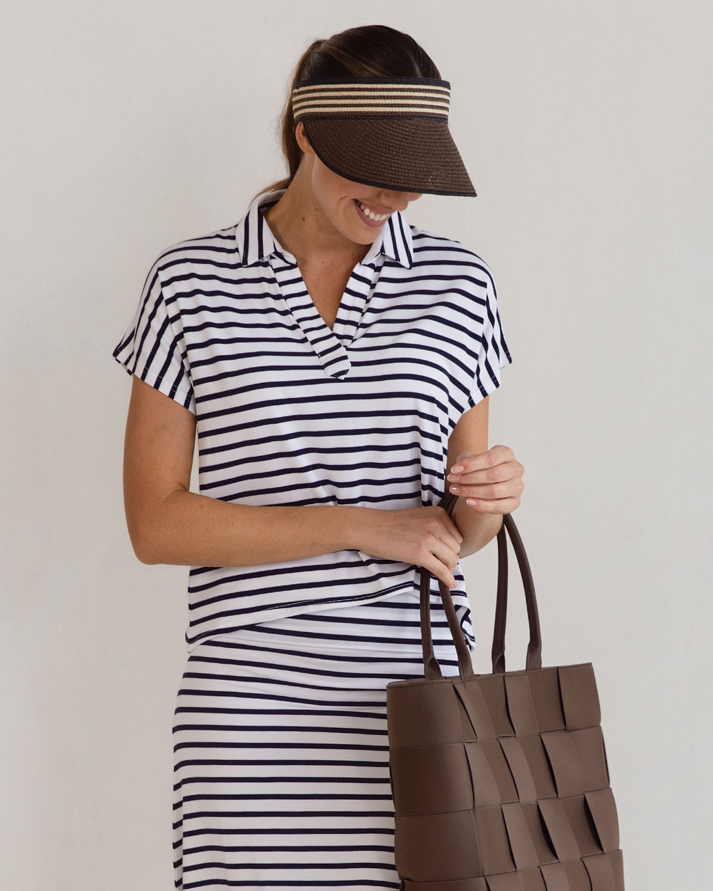 Image of a model wearing Tops. Product name - Rush Bamboo Short Sleeve Collared Polo Top Navy & White Stripe in Navy & White Stripe colour by brand - Lou Lou