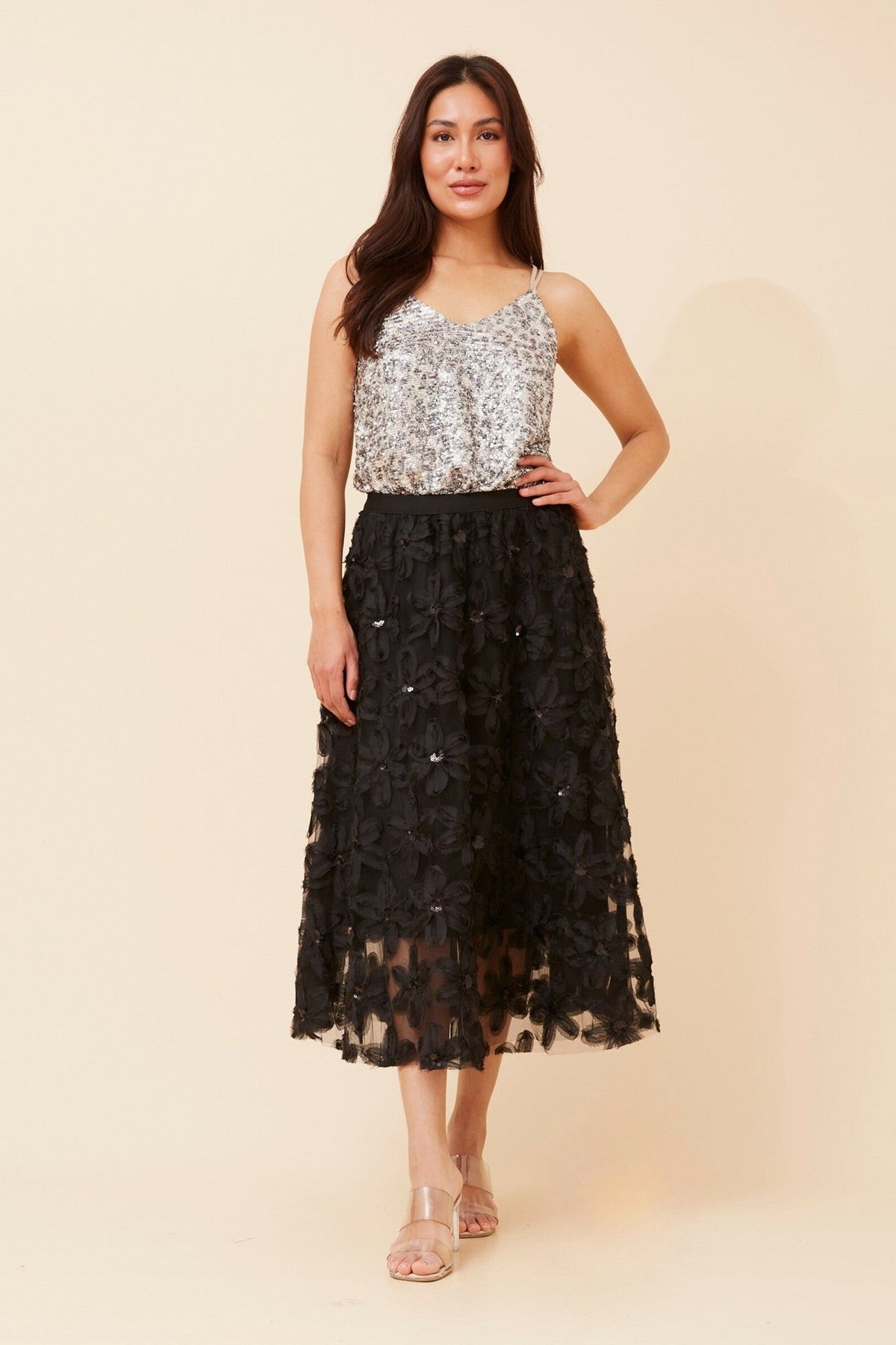 Image of a model wearing Skirts. Product name - PHOENIX FLORAL EMBROIDERED SKIRT in Black colour by brand - IZABEL