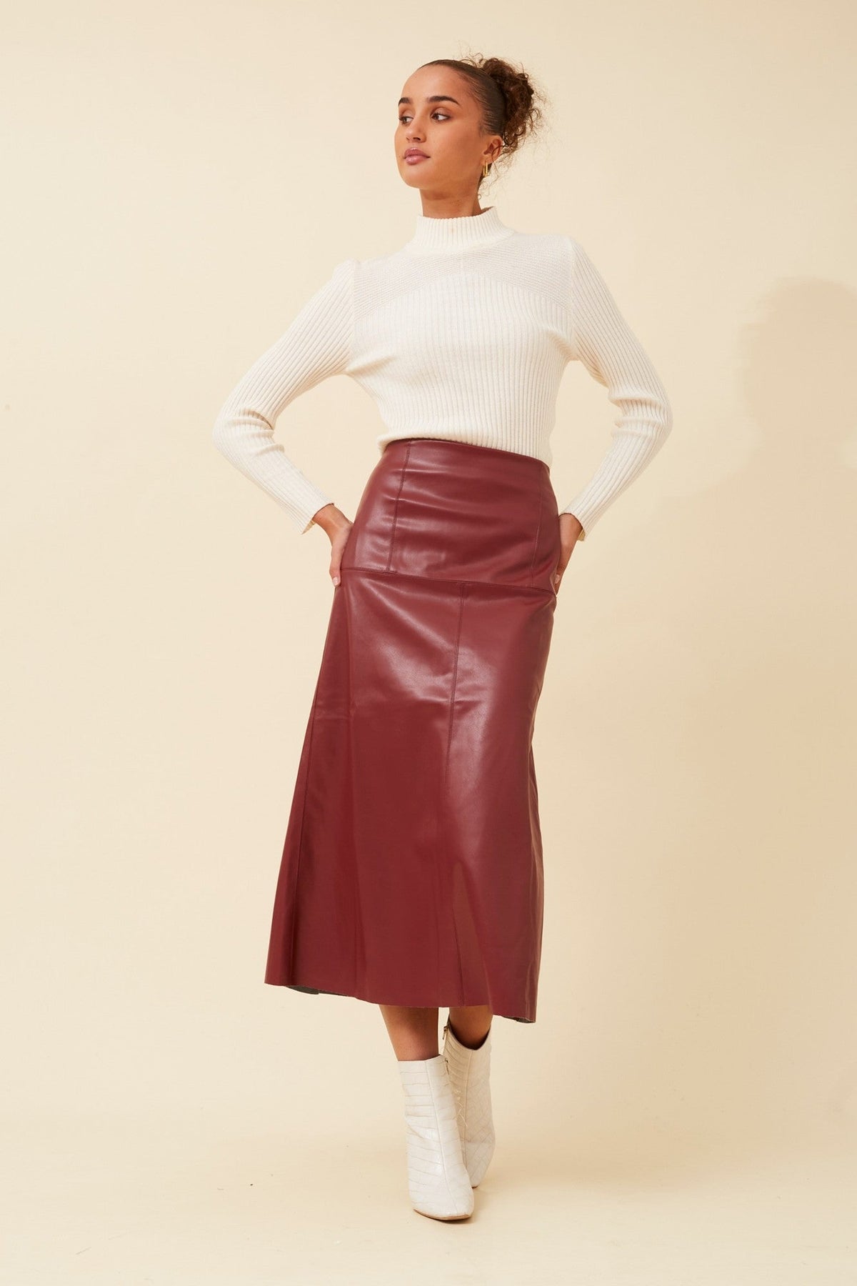 Image of a model wearing Skirts. Product name - AUBREE VEGAN LEATHER SKIRT in Black colour by brand - Caroline Morgan Australia
