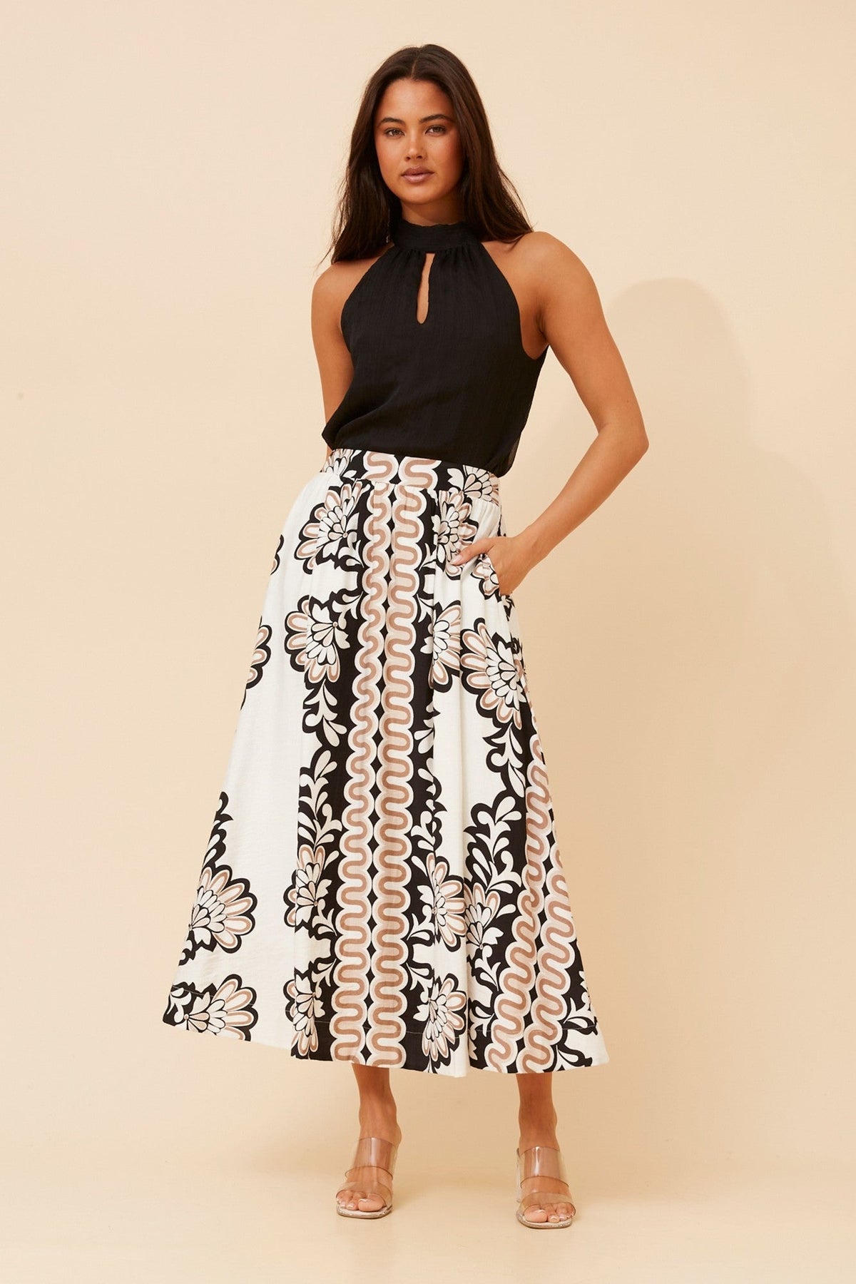 Image of a model wearing Skirts. Product name - TOSCA BORDER PRINT MAXI SKIRT in Multi Beige colour by brand - Caroline Morgan Australia