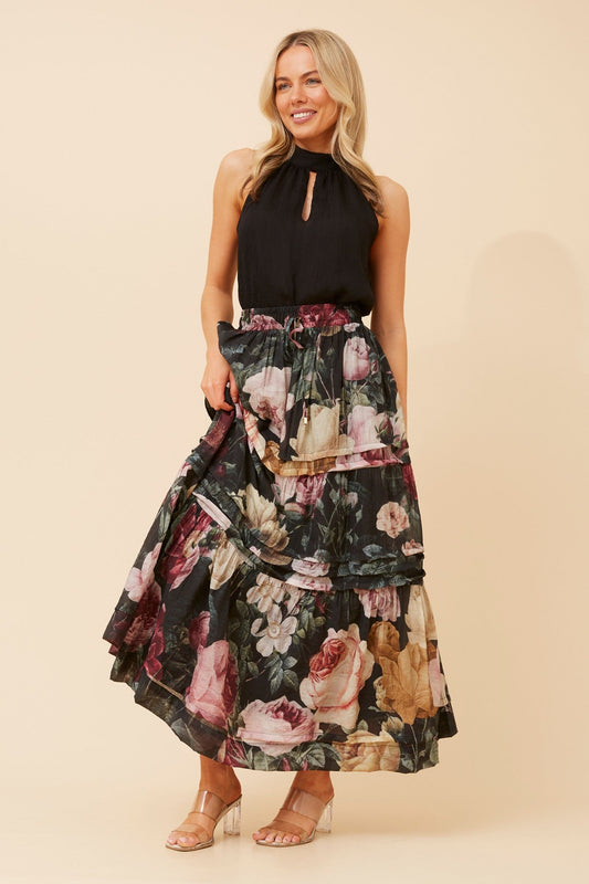Image of a model wearing Skirts. Product name - NATE FLORAL PRINT MAXI SKIRT in Multi Black colour by brand - Stella + Biancca