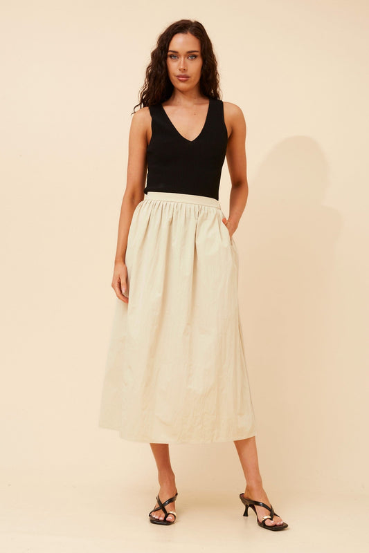 Image of a model wearing Skirts. Product name - HADI SOLID MIDI SKIRT in Clay colour by brand - Caroline Morgan Australia
