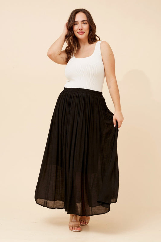 Image of a model wearing Skirts. Product name - LAYTON SOLID MAXI SKIRT in Black colour by brand - Caroline Morgan Australia