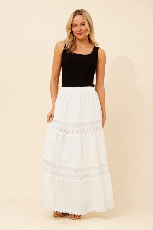 Image of a model wearing Skirts. Product name - ODITI LACE MAXI SKIRT in White colour by brand - Caroline Morgan Australia
