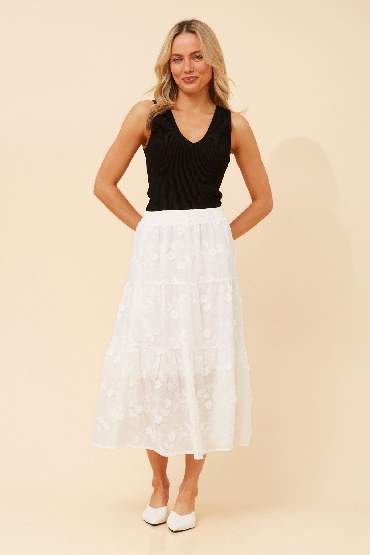 Image of a model wearing Skirts. Product name - LICIA FLORAL EMBROIDERED MIDI SKIRT in White colour by brand - Caroline Morgan Australia