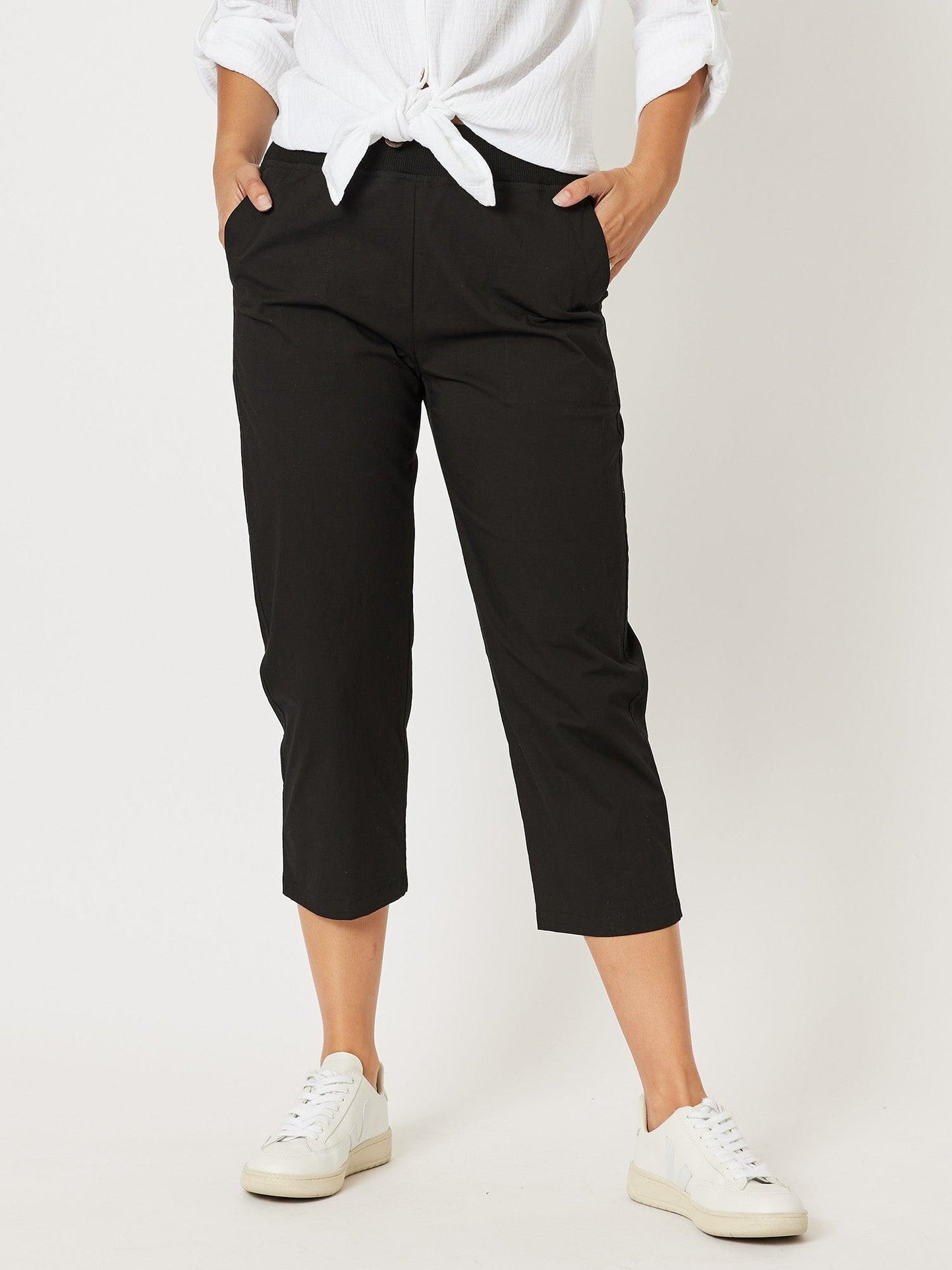 Image of a model wearing Pants. Product name - Santorini Cotton Capri Pant Black in Black colour by brand - Threadz