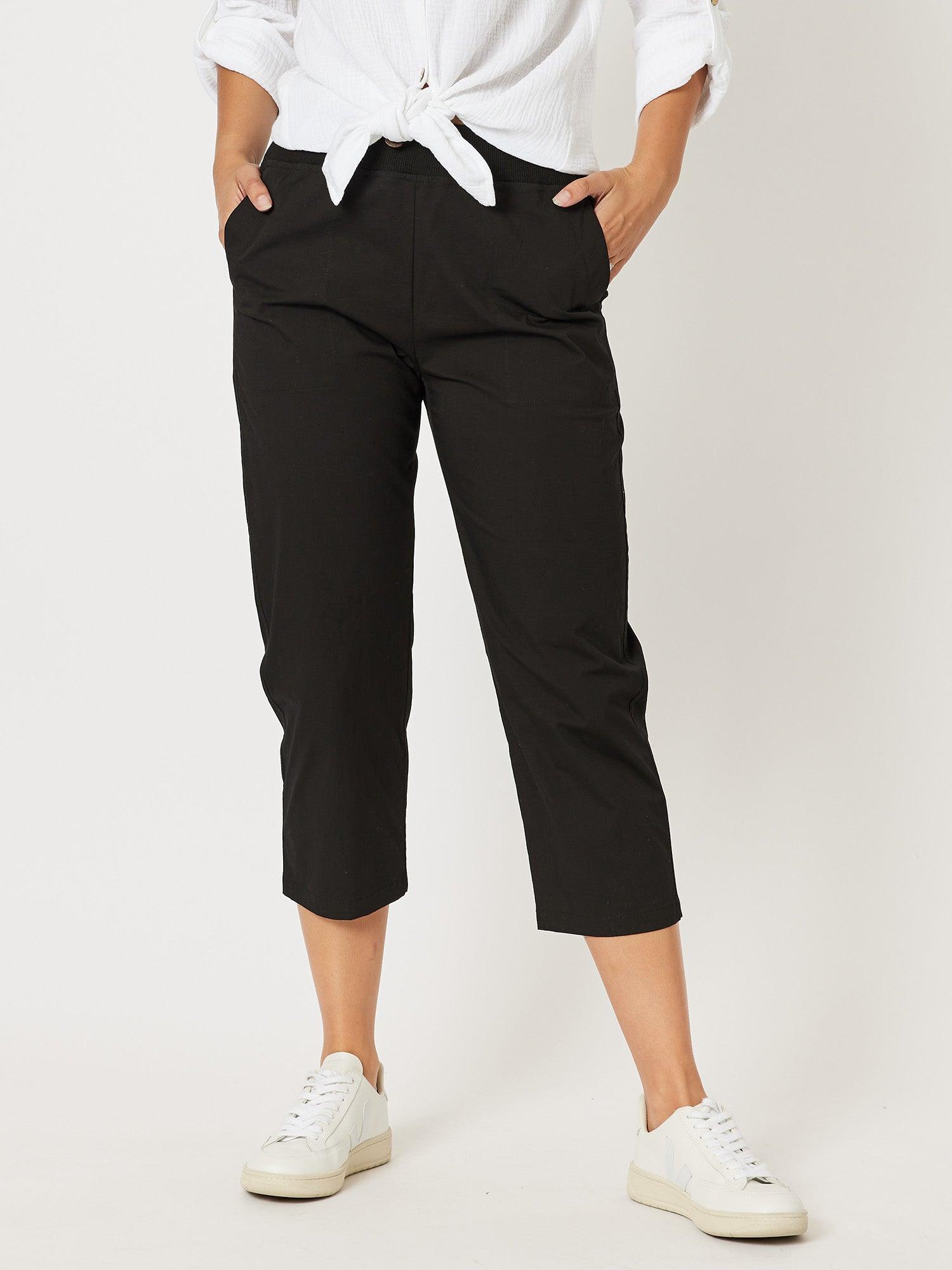 Image of a model wearing Pants. Product name - Santorini Cotton Capri Pant Black in Black colour by brand - Threadz