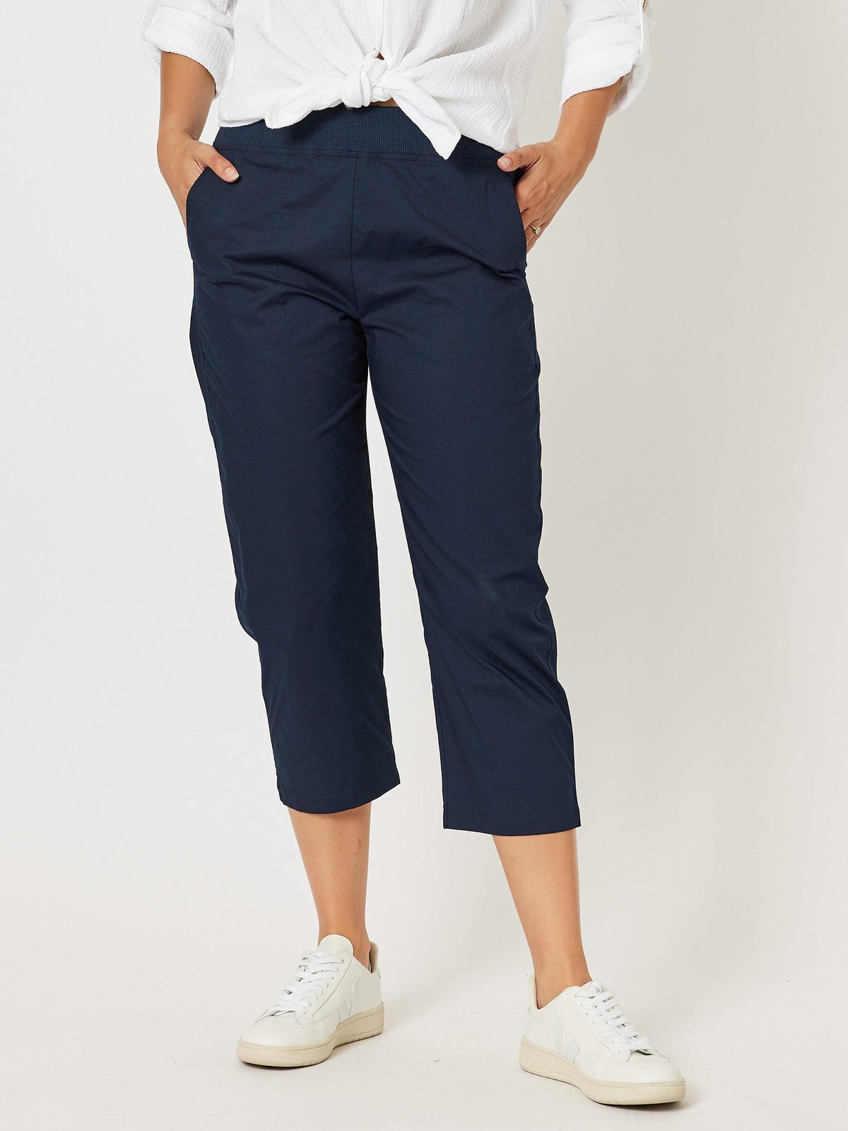 Image of a model wearing Pants. Product name - Santorini Cotton Capri Pant Navy in Navy colour by brand - Threadz