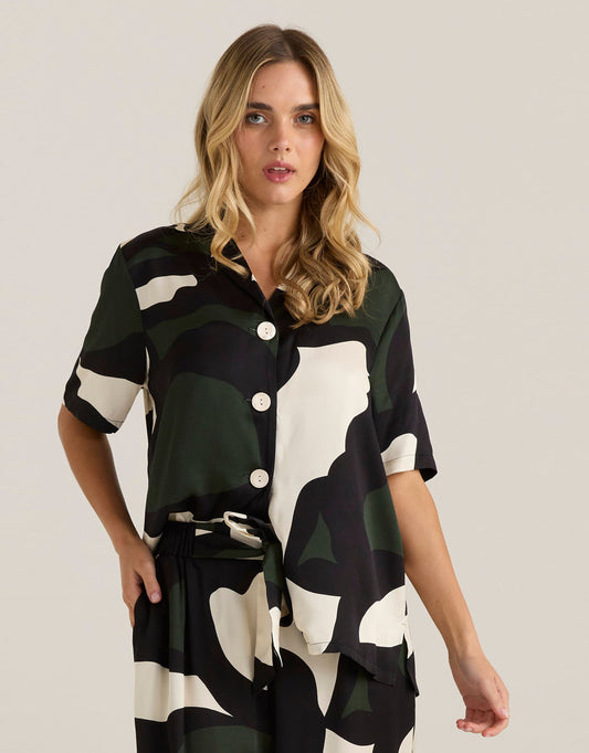 Image of a model wearing Tops. Productname: Tarni Satin Shirt - in Iris Abstract Print colour by brand - Sass Clothing