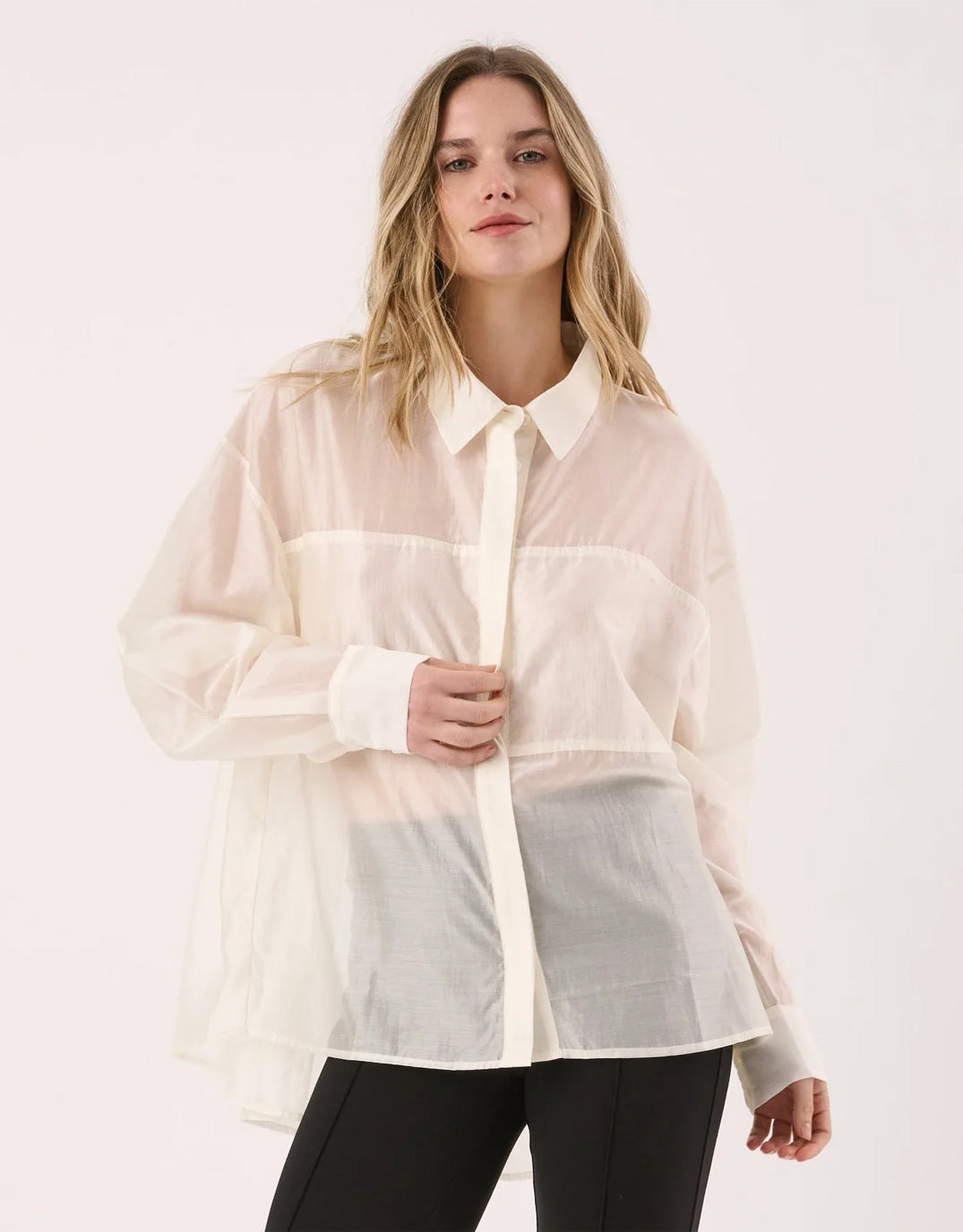 Image of a model wearing Tops. Product name - Val Oversized Shirt White in White colour by brand - Sass Clothing