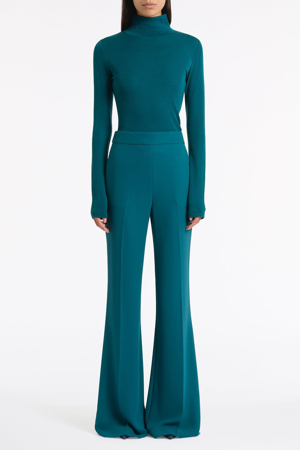 Image of a model wearing Tops. Product name - Serpentine Babywool High Neck Top in Green colour by brand - Carla Zampatti