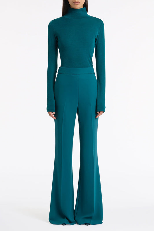 Image of a model wearing Tops. Product name - Serpentine Babywool High Neck Top in Green colour by brand - Carla Zampatti