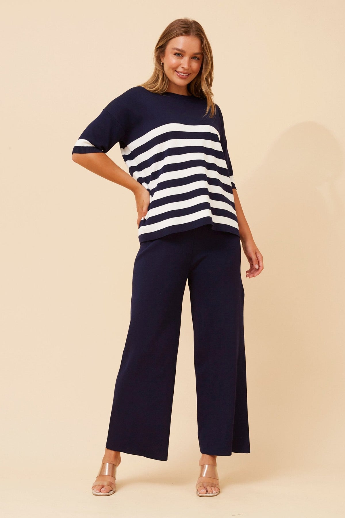Image of a model wearing Outerwear. Product name - LISINDA TWO-PIECE KNITTED SET in Navy colour by brand - Caroline Morgan Australia