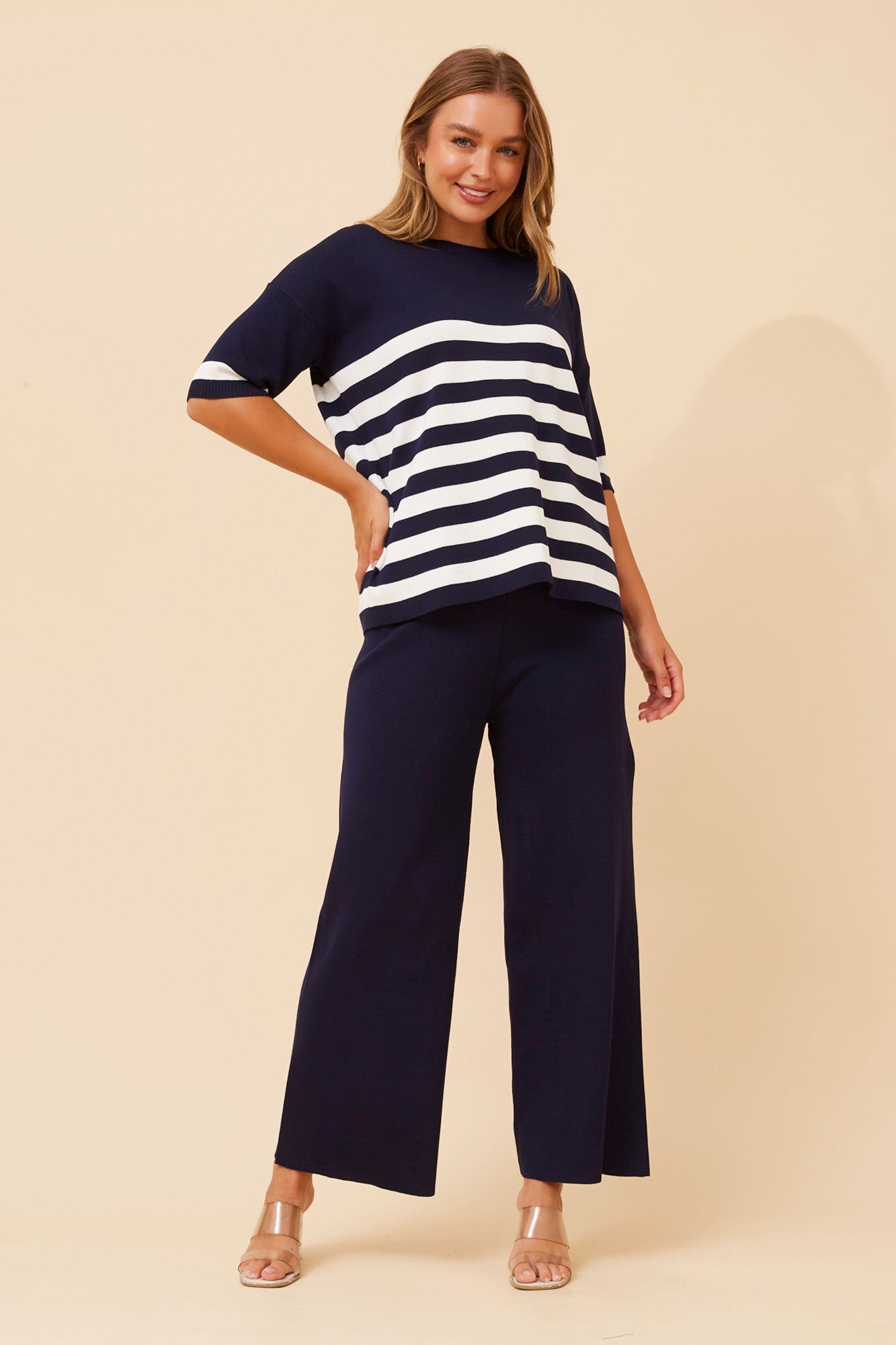 Image of a model wearing Outerwear. Product name - LISINDA TWO-PIECE KNITTED SET in Navy colour by brand - Caroline Morgan Australia