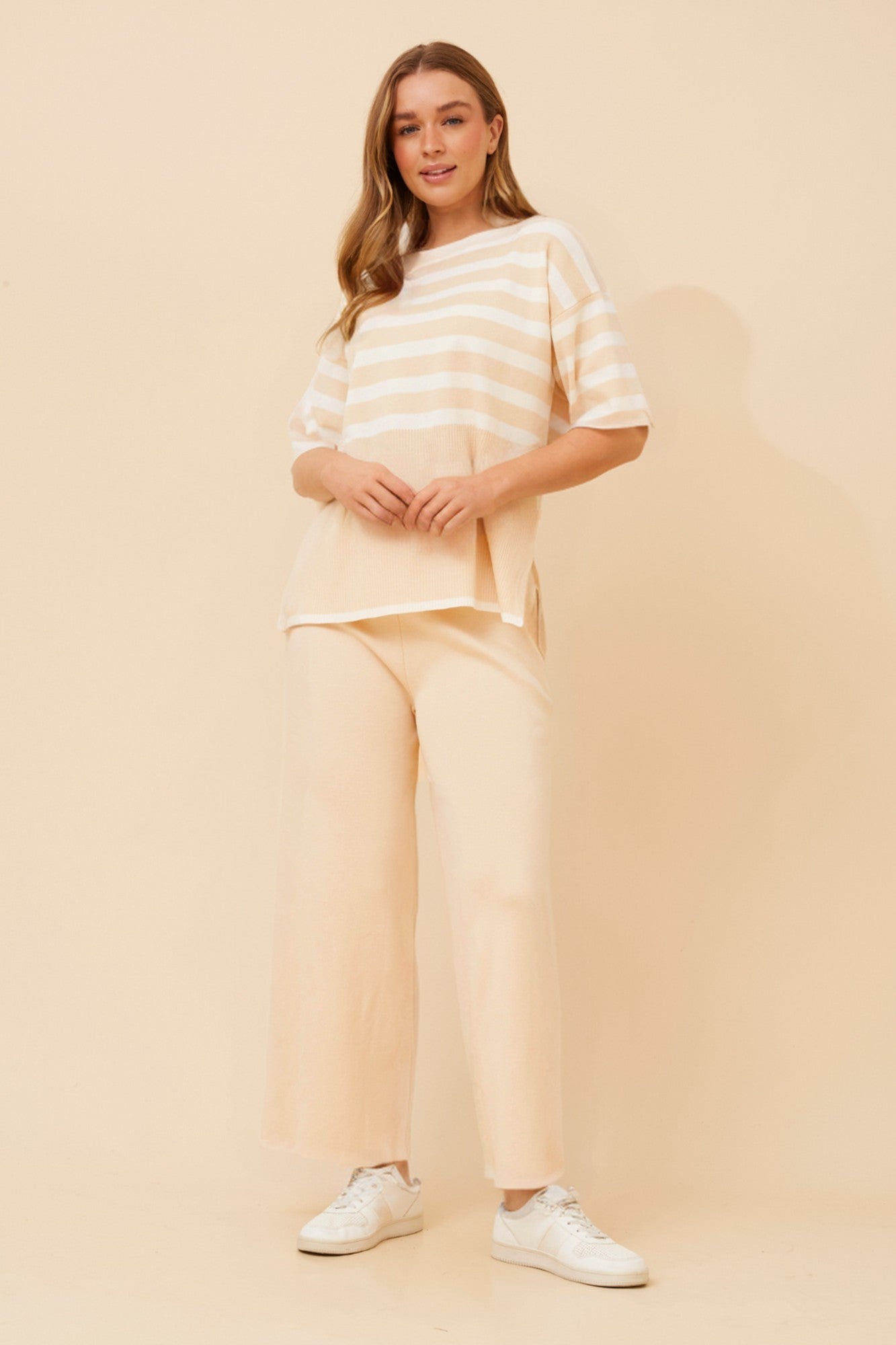 Image of a model wearing Outerwear. Product name - LISINDA STRIPE PRINT KNITTED SET in Beige colour by brand - Caroline Morgan Australia