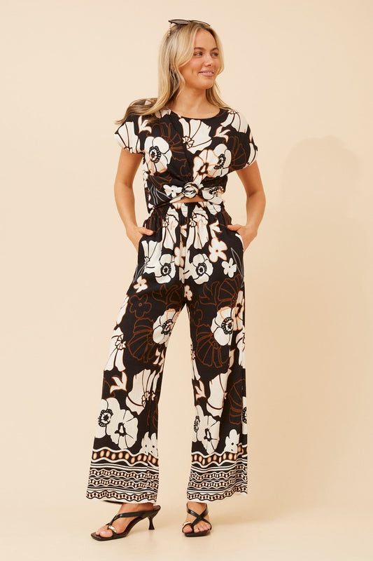 Image of a model wearing Tops. Product name - RAILEY FLORAL TWO-PIECE SET in Black colour by brand - Caroline Morgan Australia