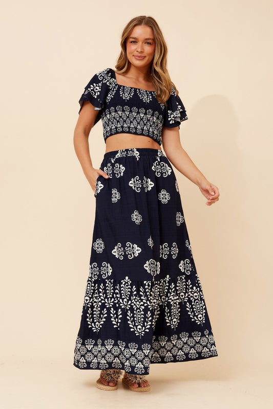 Image of a model wearing Skirts. Product name - RIELLE BORDER PRINT SET in Navy colour by brand - Caroline Morgan Australia