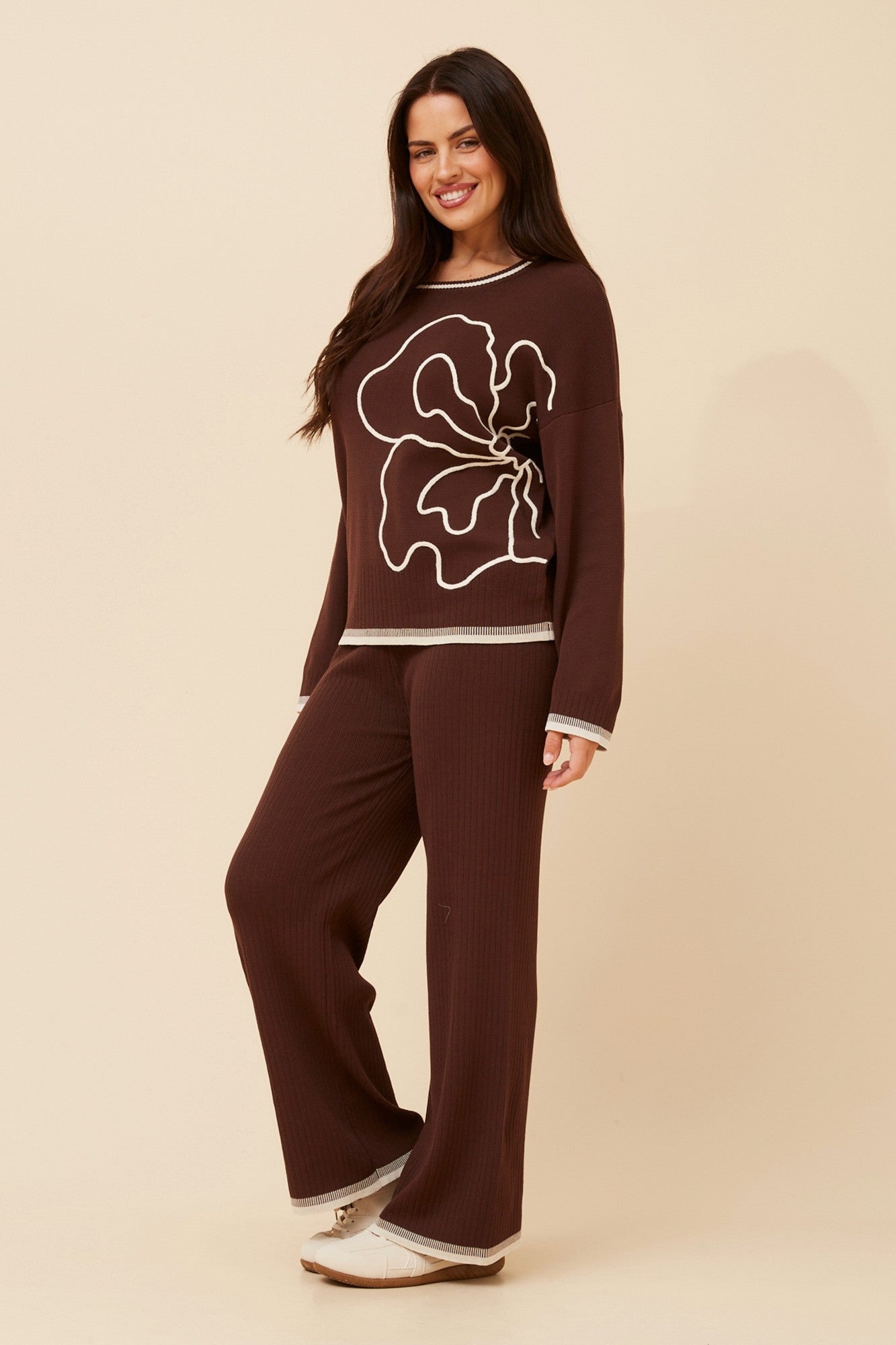 Image of a model wearing Tops. Product name - ERLINDA TWO-PIECE KNIT SET in Black colour by brand - Caroline Morgan Australia