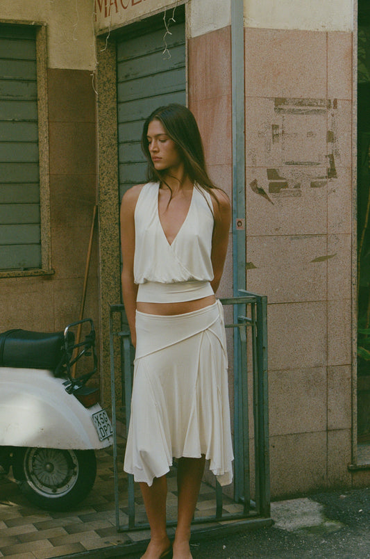 Image of a model wearing Skirts. Product name - Sharni Skirt in Off White colour by brand - With Jéan