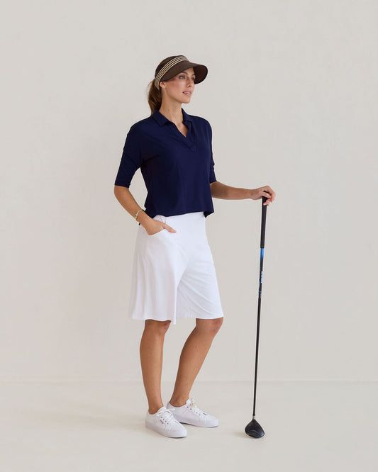Image of a model wearing Tops. Product name - Khan Bamboo 3/4 Sleeve Collared Polo Top Navy in Navy colour by brand - Lou Lou