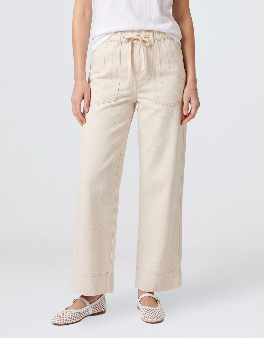 Image of a model wearing Pants. Product name - Sofia Pant Sand/Neon Speck in Sand/Neon Speck colour by brand - Kireina