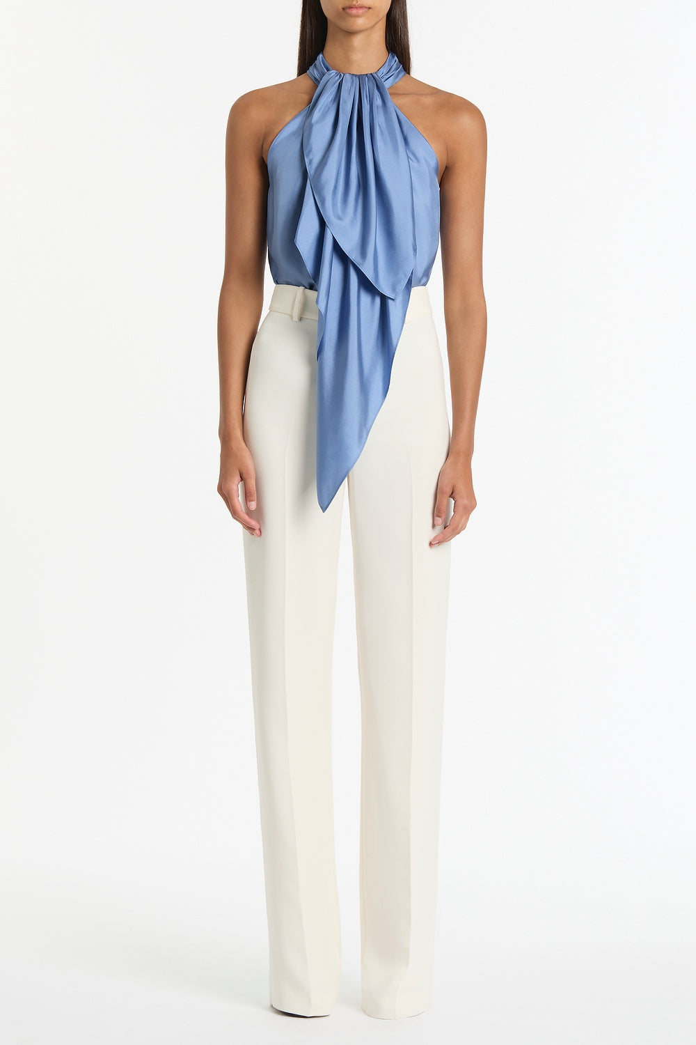 Image of a model wearing Tops. Product name - Steel Blue Silk Twill Ruffle Halter Top in Blue colour by brand - Carla Zampatti