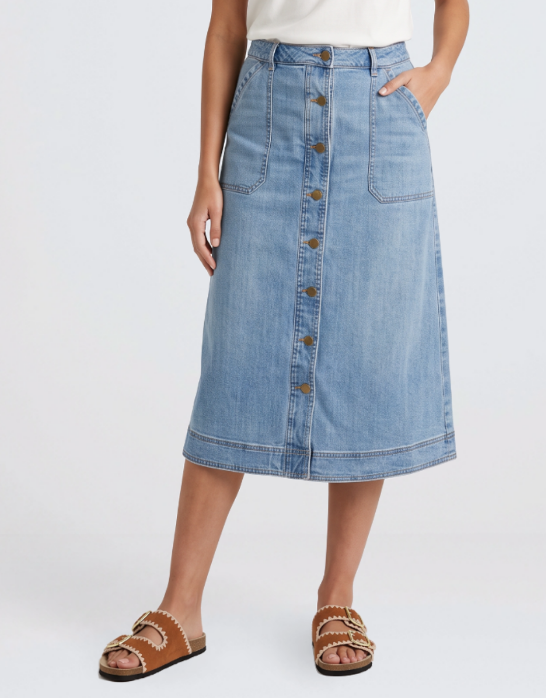 Image of a model wearing Skirts. Product name - Stevie Midi Denim Skirt Mid Wash in Mid Wash colour by brand - White & Co.