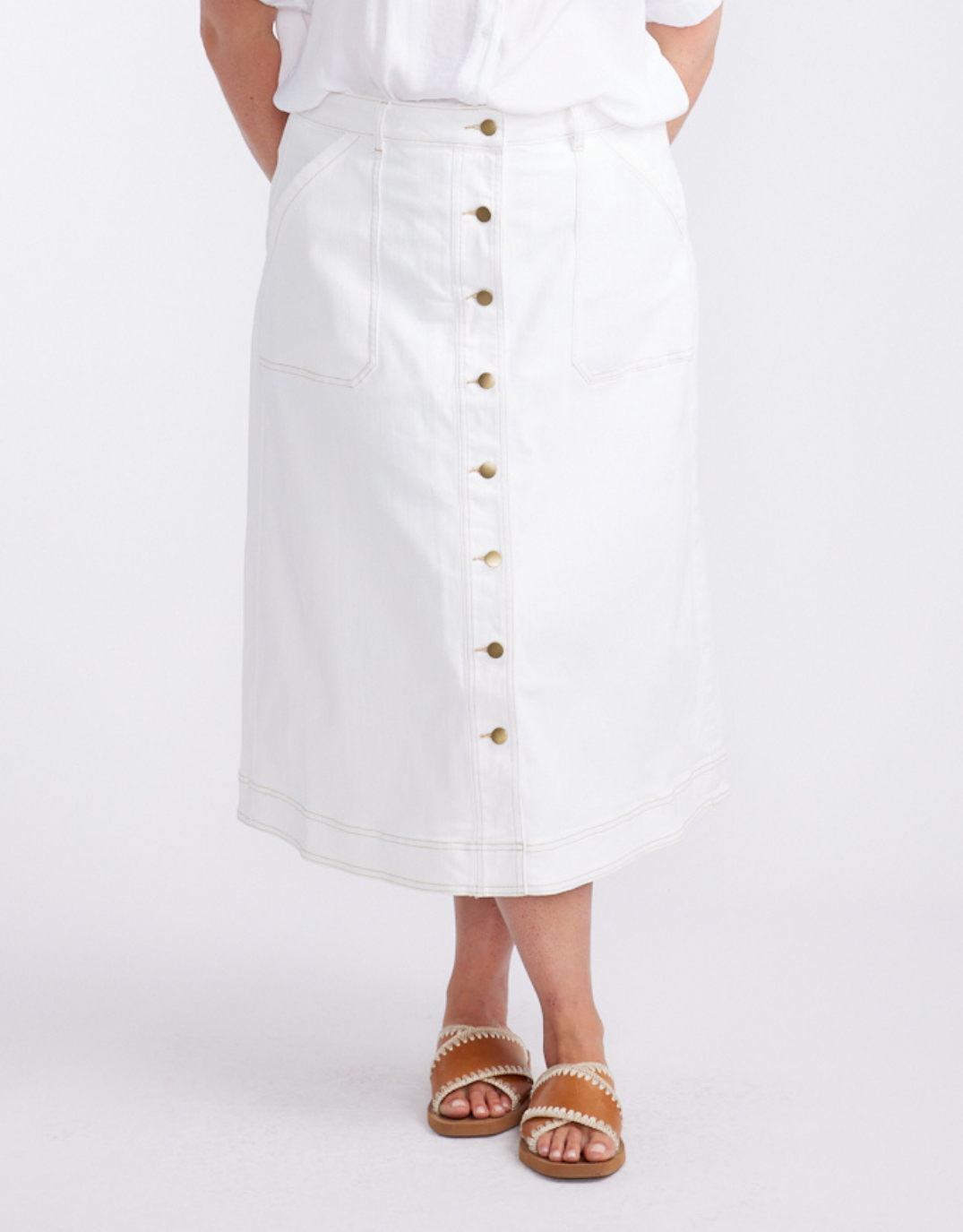 Image of a model wearing Skirts. Product name - Stevie Midi Denim Skirt White in White colour by brand - White & Co.