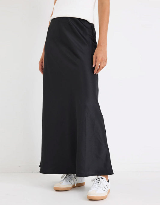 Image of a model wearing Skirts. Productname: Prodigy Satin Bias Maxi Skirt - in Black colour by brand - Stories Be Told