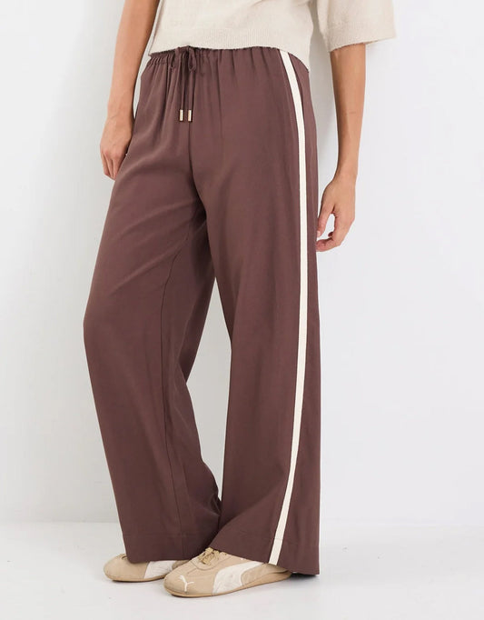 Image of a model wearing Pants. Product name - Townie Tape Wide Leg Pant Chocolate Stripe in Chocolate Stripe colour by brand - Stories Be Told