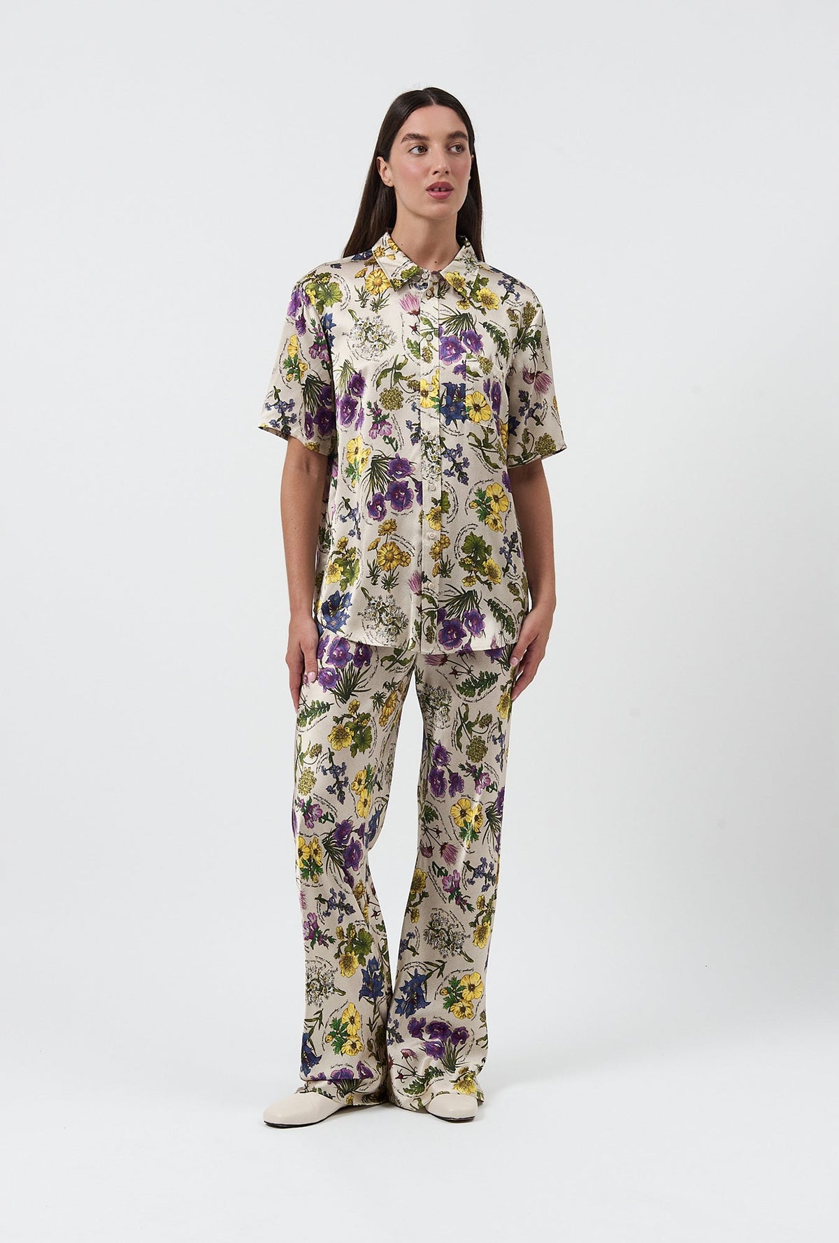 Image of a model wearing Pants. Product name - Bias Cut Pants Endangered Flowers in Endangered Flowers colour by brand - Silk Laundry