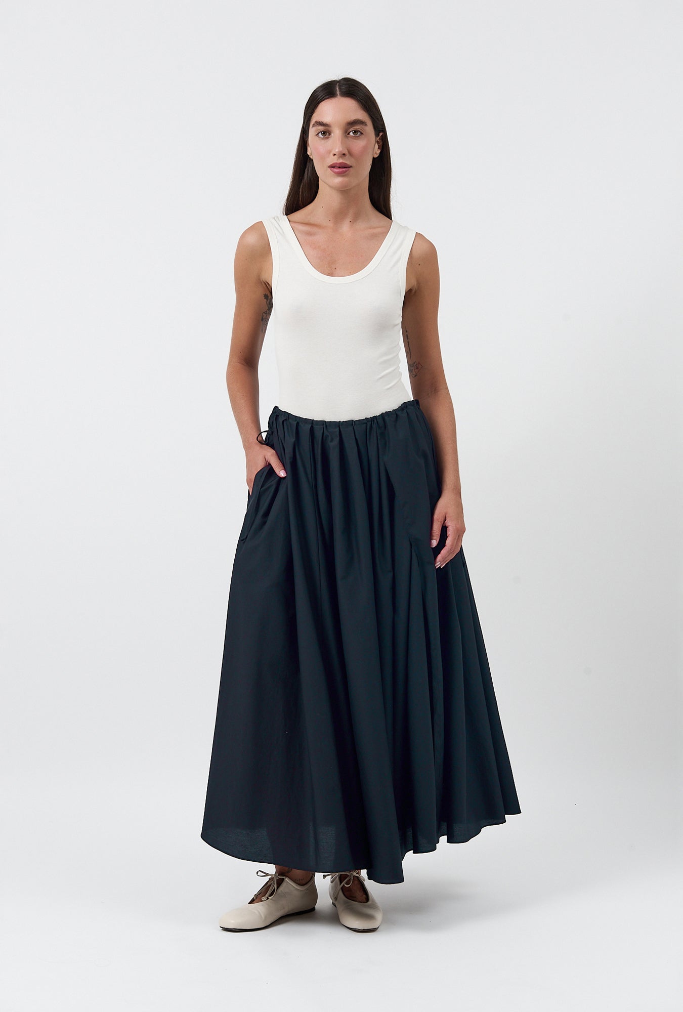Image of a model wearing Skirts. Product name - Daisy Skirt Black in Black colour by brand - Silk Laundry