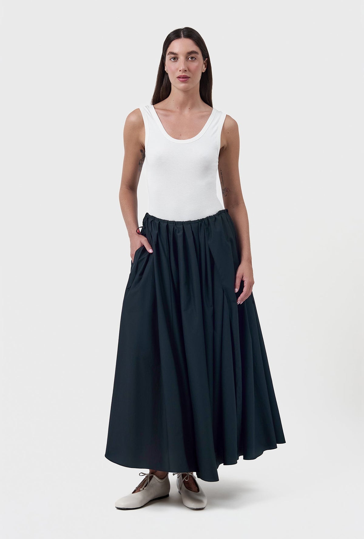 Image of a model wearing Skirts. Product name - Daisy Skirt Black in Black colour by brand - Silk Laundry