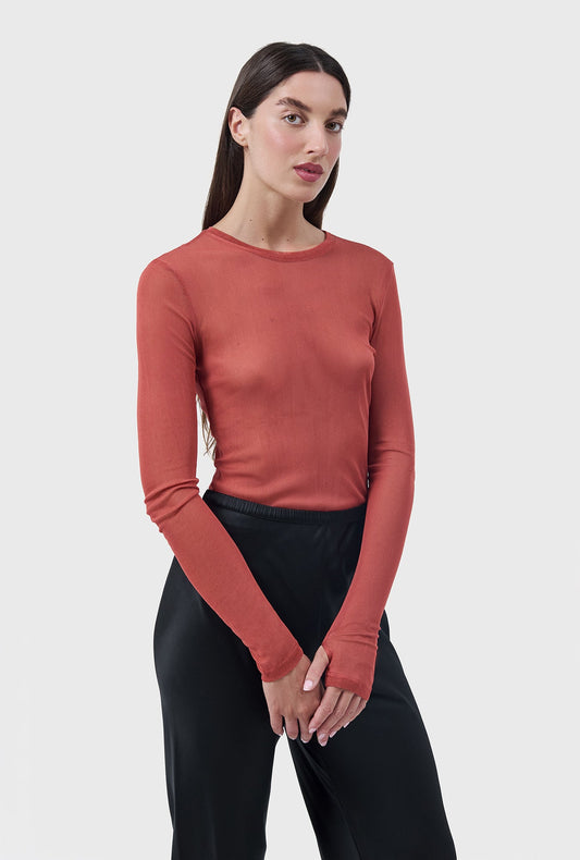 Image of a model wearing Tops. Product name - Mesh Long Sleeve Top Blush Red in Blush Red colour by brand - Silk Laundry