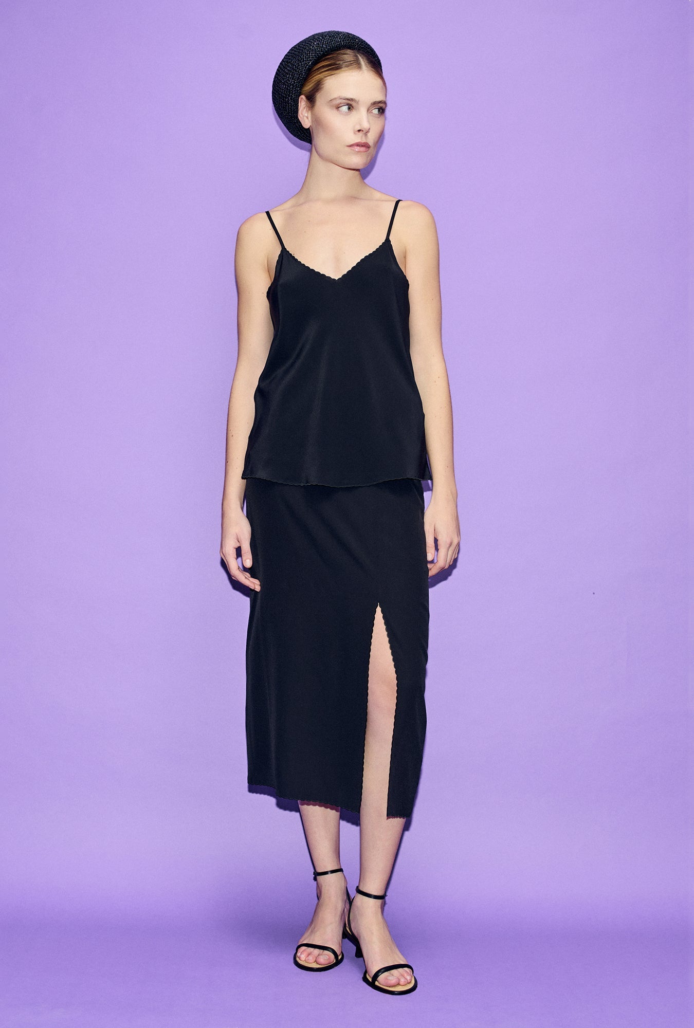 Image of a model wearing Skirts. Product name - Scallop Skirt Black in Black colour by brand - Silk Laundry